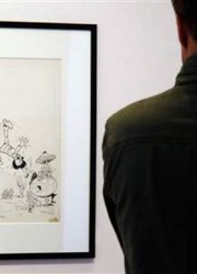 A visitor looks at "The Smurfs and the Magic Flute," expected to be the highlight of an upcoming art auction