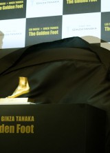 Rodrigo Messi, brother of football star Lionel Messi of Argentine (R) and Ginza Tanaka President Masakazu Tanaka (L) unveil the golden replica of Lionel Messi's left foot