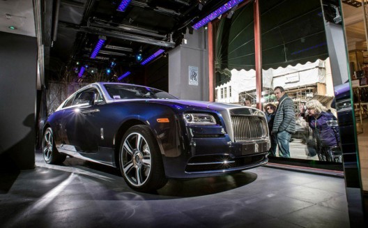 A new Rolls-Royce Wraith coupé car is displayed in a window of Harrods department store in Knightsbridge, London, England