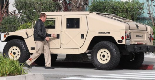 Arnold Schwarzenegger is driving trough the town in Hummer on which side is written "Terminator"