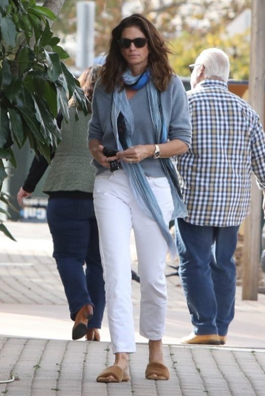 Cindy Crawford wearing a baby blue scarf and matching sweater out in Malibu